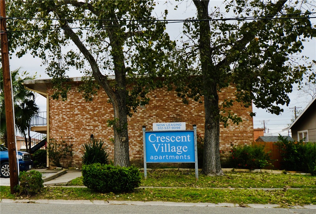 a sign board with tall buildings