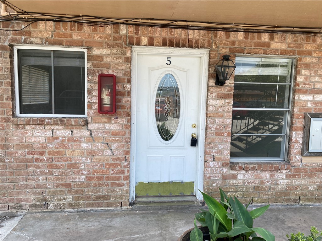 1004 Austin Street, Unit 5 Portland, TX 78374 - Photo 3 of 9 a front view of a house with entryway