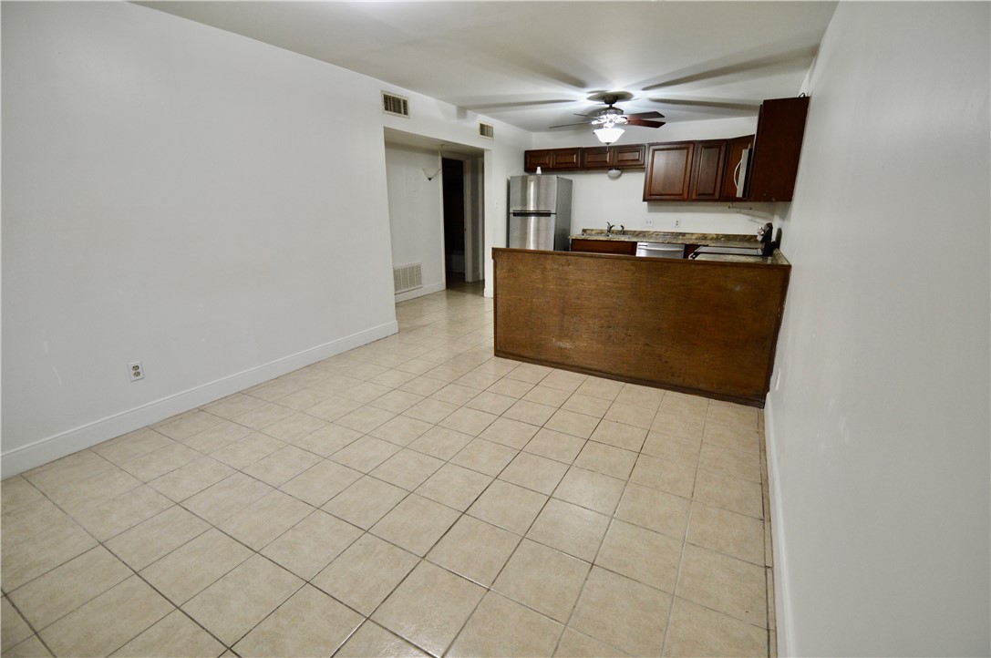 1004 Austin Street, Unit 3 Portland, TX 78374 - Photo 4 of 12 a kitchen with stainless steel appliances a stove top oven and cabinets
