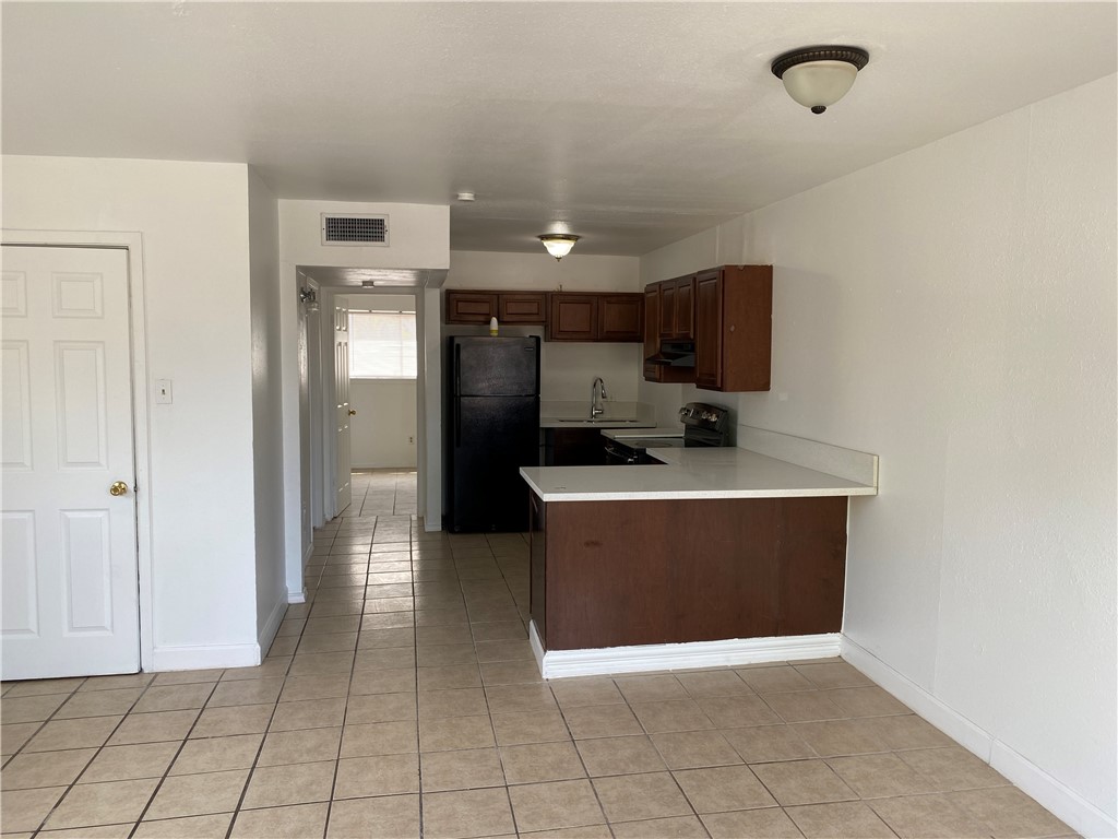 1004 Austin Street, Unit 5 Portland, TX 78374 - Photo 4 of 9 a view of a kitchen with a sink and a refrigerator
