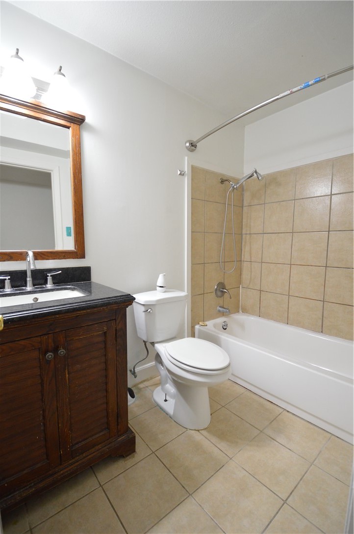 1004 Austin Street, Unit 3 Portland, TX 78374 - Photo 7 of 12 a bathroom with a sink a toilet and shower