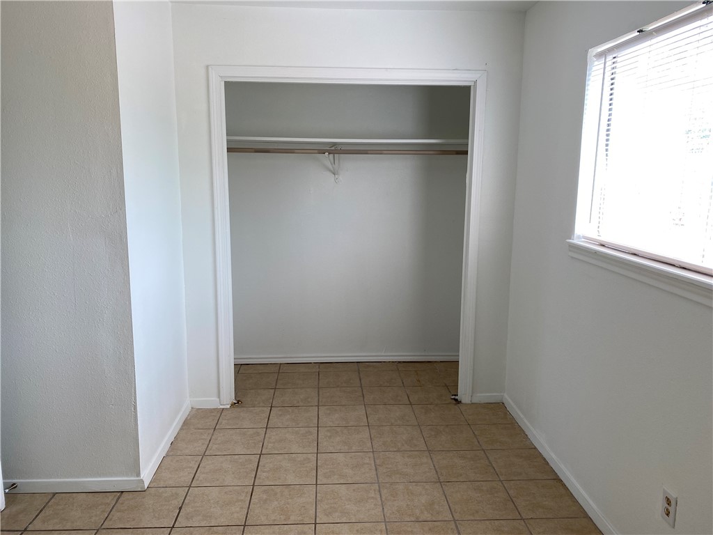 1004 Austin Street, Unit 5 Portland, TX 78374 - Photo 9 of 9 a view of an empty room with a window
