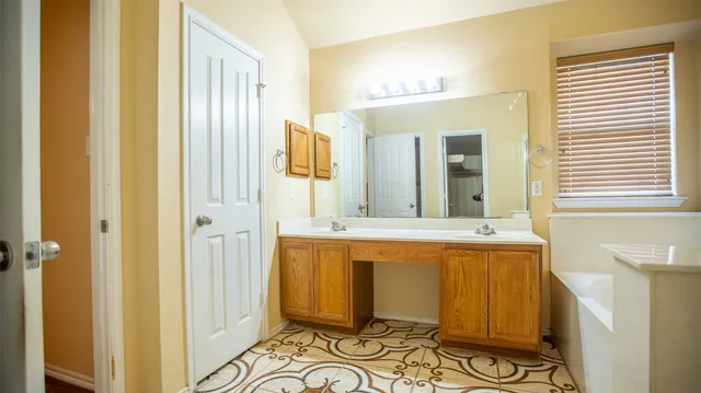 a spacious bathroom with a bathtub and a sink