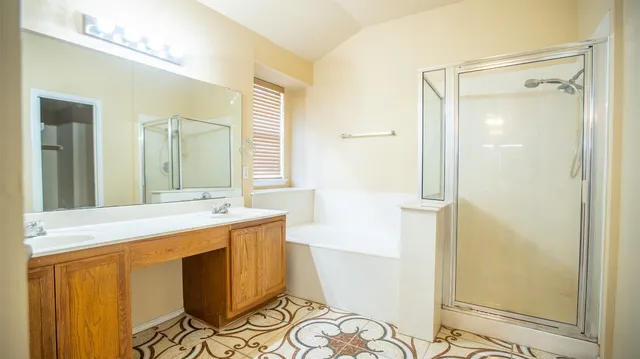 a bathroom with a granite countertop sink a mirror and a shower