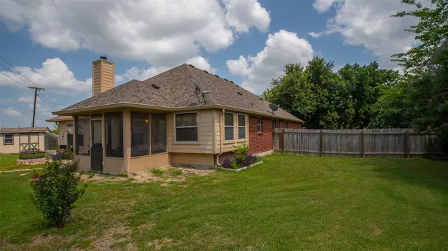 a view of a house with a yard and sitting area