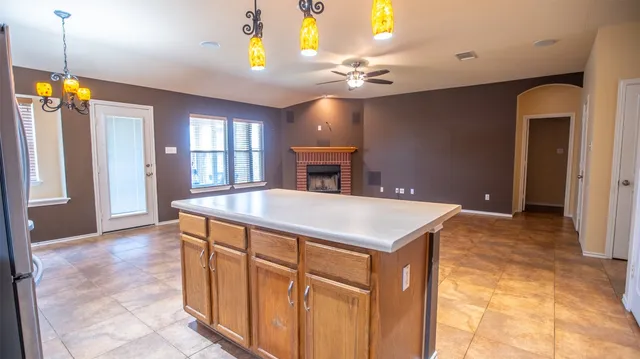 a view of a kitchen with a sink cabinet and a chandelier