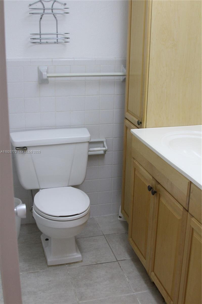 1300 North Ocean Boulevard, Unit 111 Pompano Beach, FL 33062 - Photo 15 of 26 a bathroom with a toilet and a sink