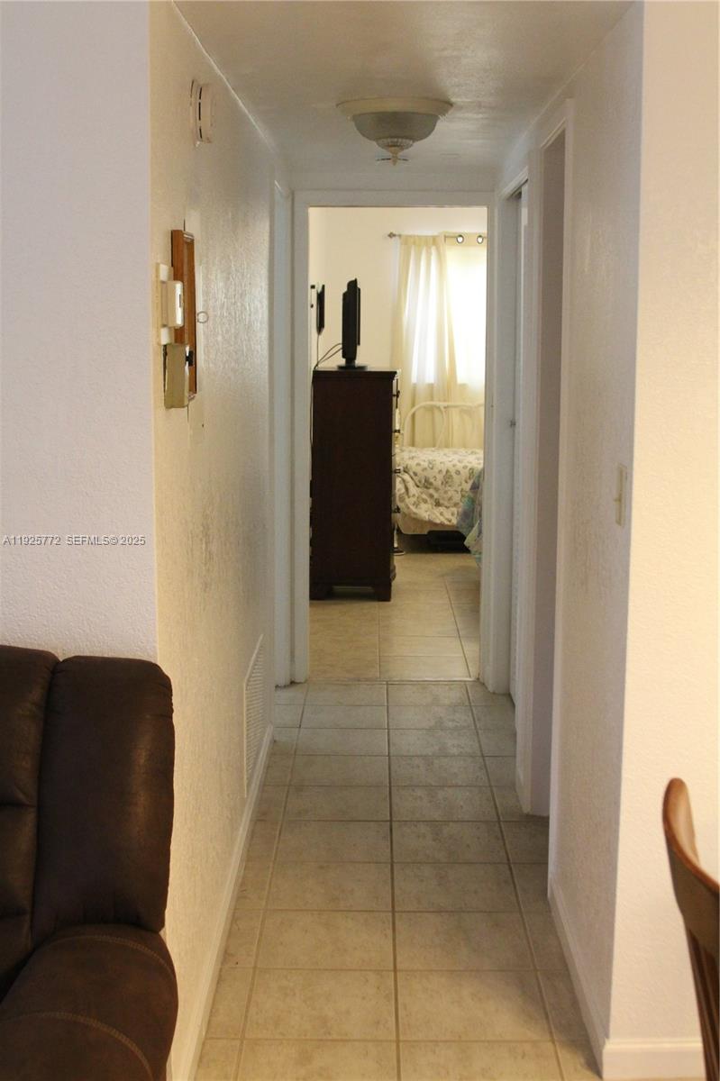 1300 North Ocean Boulevard, Unit 111 Pompano Beach, FL 33062 - Photo 17 of 26 a living room with furniture and a window