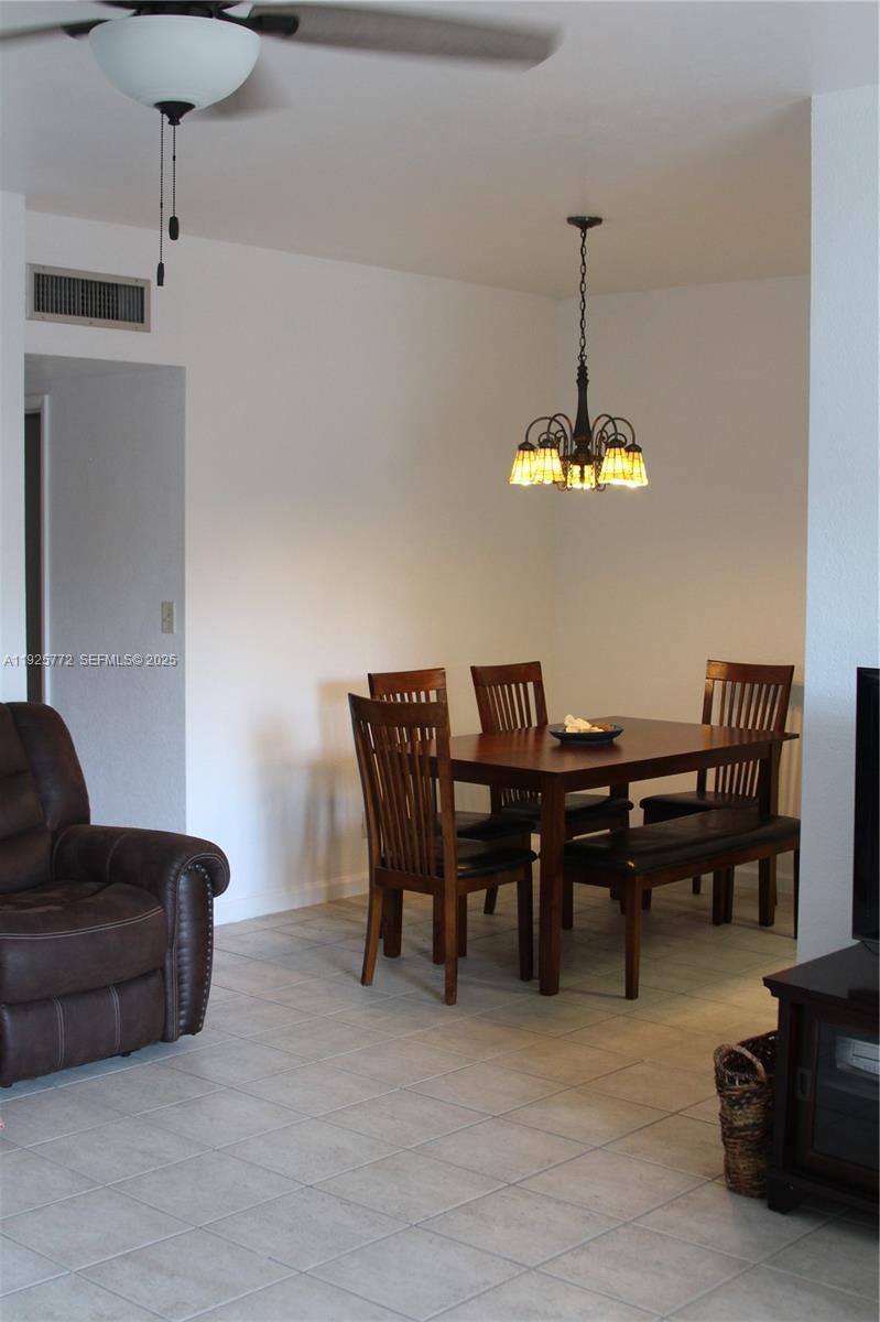 1300 North Ocean Boulevard, Unit 111 Pompano Beach, FL 33062 - Photo 21 of 26 a dining room with furniture and chandelier