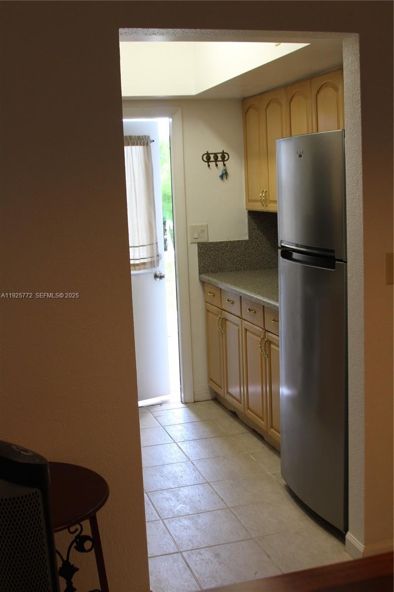1300 North Ocean Boulevard, Unit 111 Pompano Beach, FL 33062 - Photo 4 of 26 a kitchen with stainless steel appliances granite countertop a refrigerator and a sink