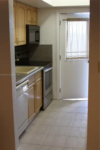 a stove top oven sitting inside of a kitchen
