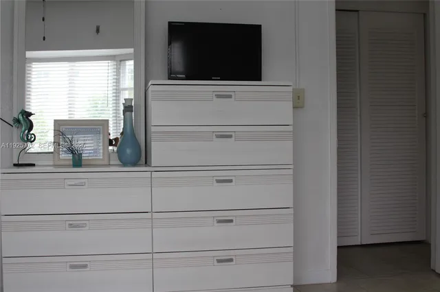 a living room with flat screen tv and a window