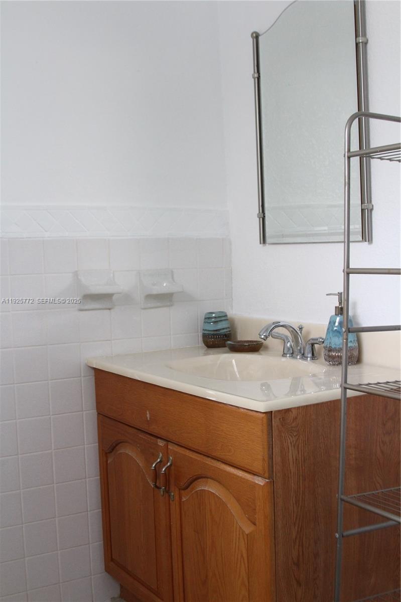 1300 North Ocean Boulevard, Unit 111 Pompano Beach, FL 33062 - Photo 7 of 26 a bathroom with a sink and a mirror