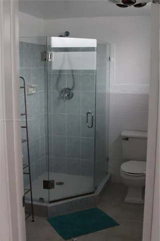 a bathroom with a shower and toilet