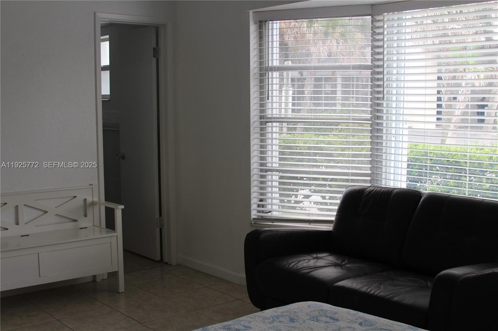 1300 North Ocean Boulevard, Unit 111 Pompano Beach, FL 33062 - Photo 10 of 26 a living room with furniture and a window