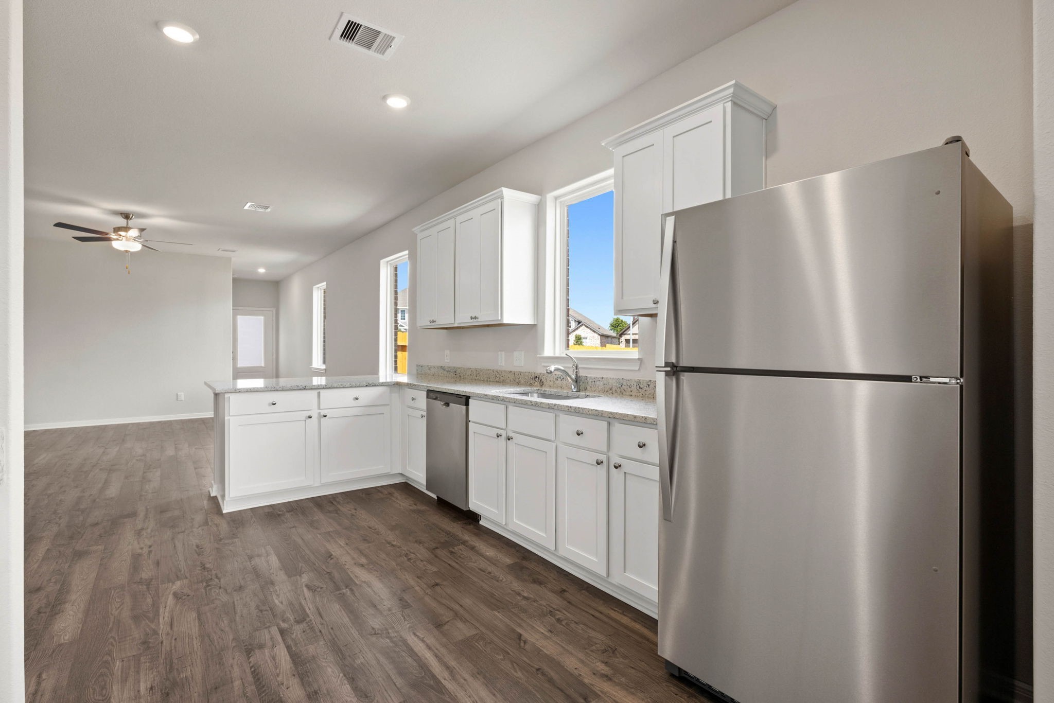 7506 Tipton Meadow Way Richmond, TX 77469 - Photo 11 of 21 a kitchen with a refrigerator a sink and cabinets