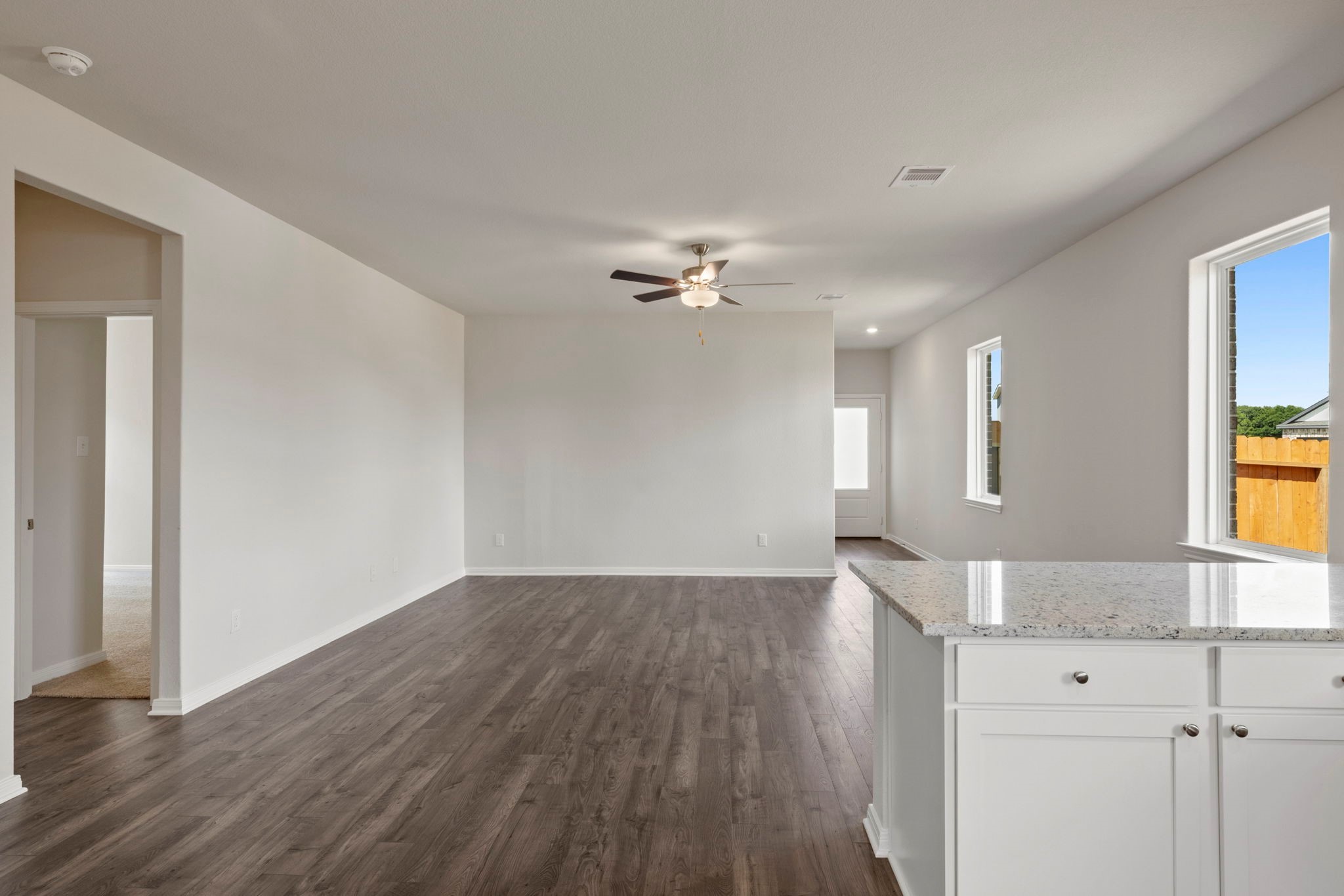 7506 Tipton Meadow Way Richmond, TX 77469 - Photo 12 of 21 a view of a livingroom with wooden floor and a ceiling fan