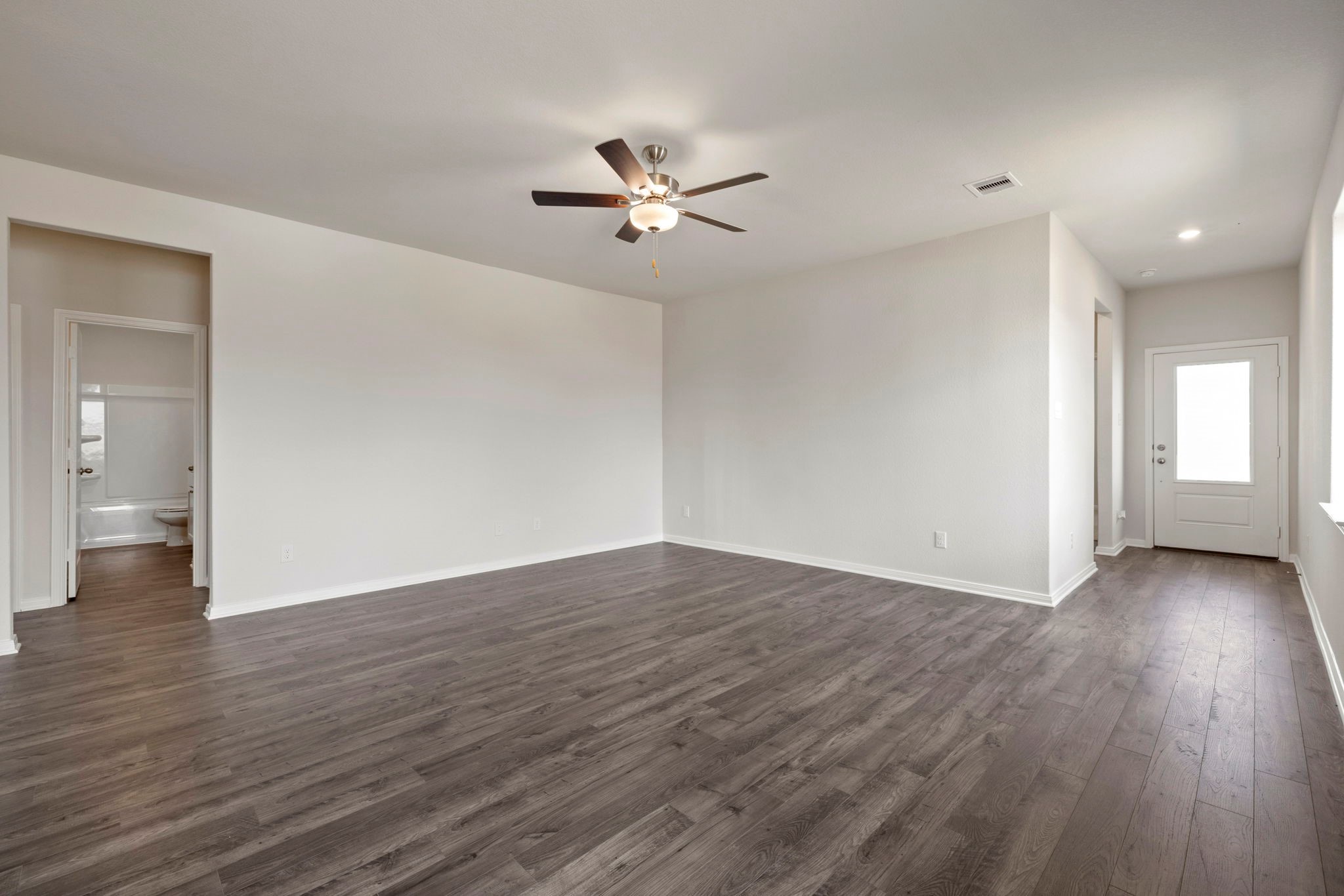 7506 Tipton Meadow Way Richmond, TX 77469 - Photo 21 of 21 a view of an empty room with window and wooden floor