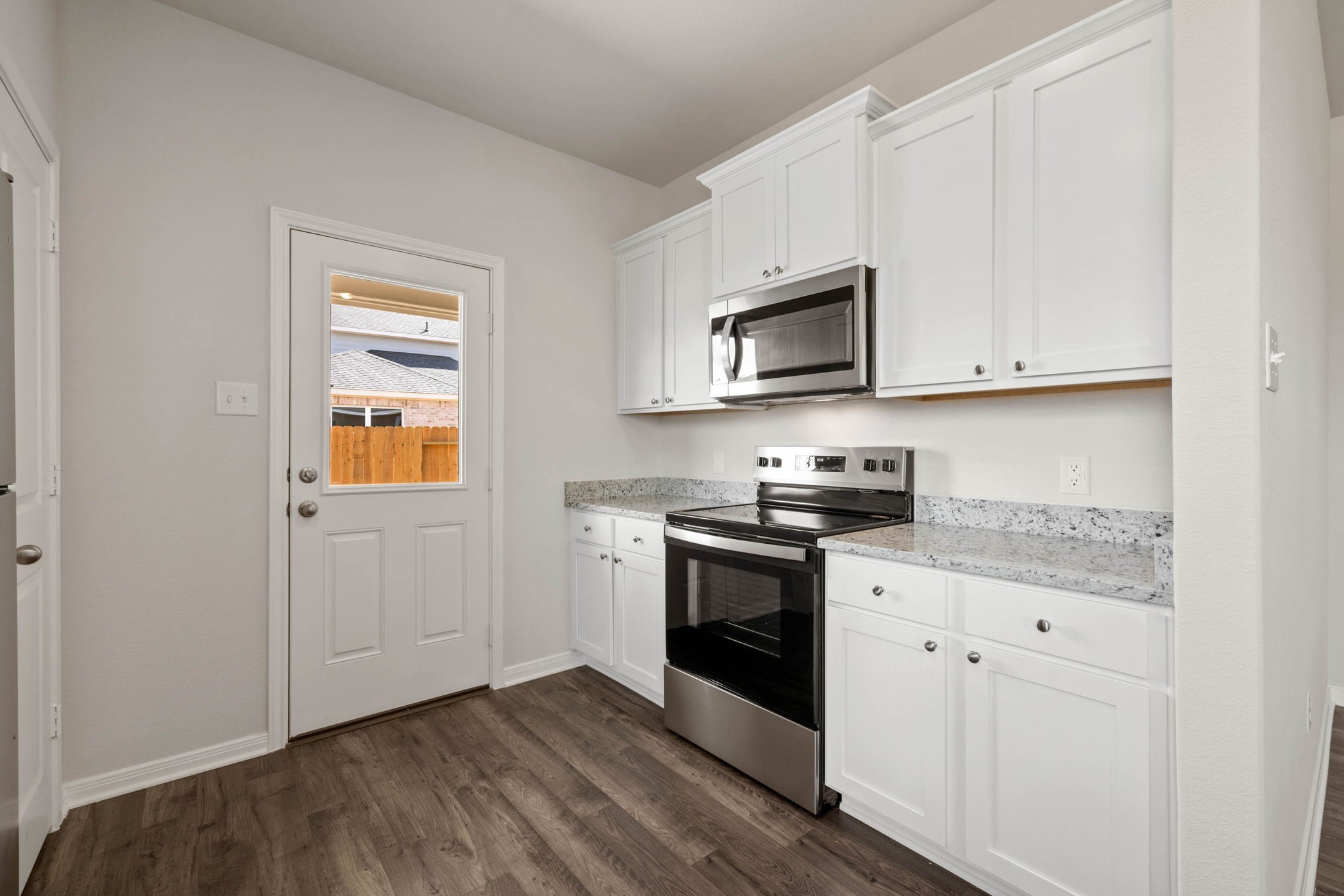 7506 Tipton Meadow Way Richmond, TX 77469 - Photo 9 of 21 a kitchen with granite countertop cabinets stainless steel appliances and a wooden floor