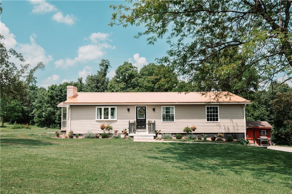 a front view of house with yard and green space