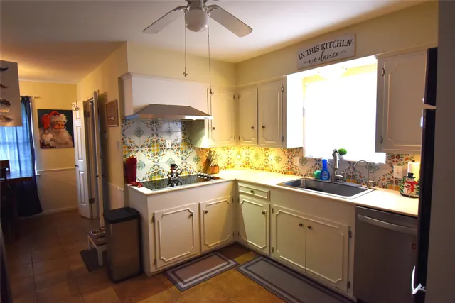 a kitchen with a sink window and cabinets