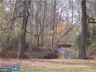 40 Jollybrook Road Levittown, PA 19056 - Photo 3 of 6 a view of a yard with trees in the background
