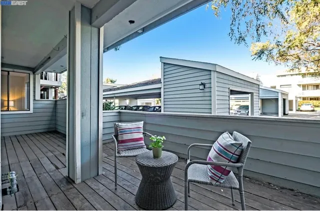 a view of a two chairs in the balcony