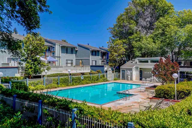 a view of a house with swimming pool and a yard
