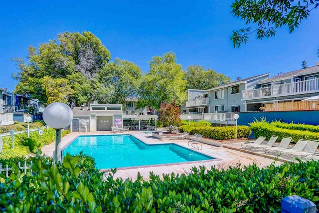 an aerial view of a house with swimming pool garden and patio