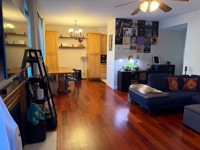 a living room with furniture and a chandelier