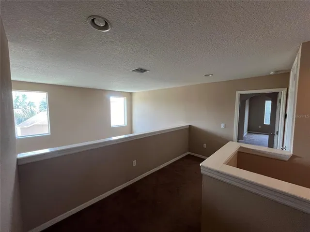 an empty room with a fireplace and a window