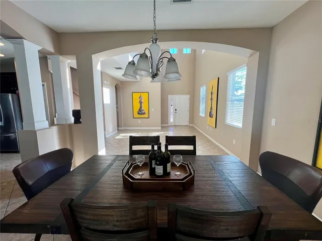 a view of a dining room with furniture and a chandelier