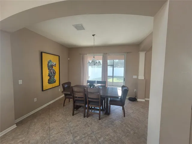 a view of a dining room with furniture and window