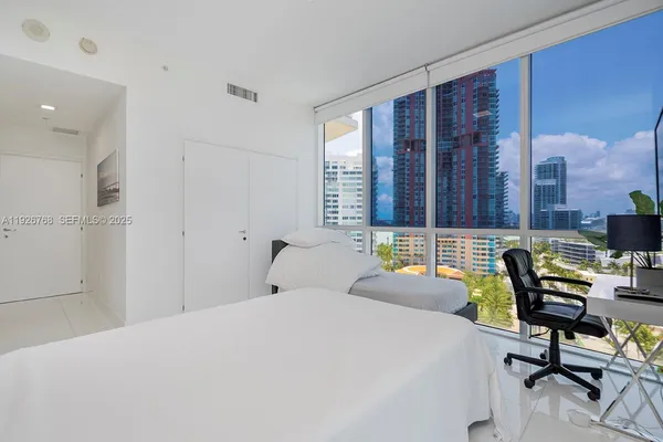 a bedroom with a bed a desk and chair