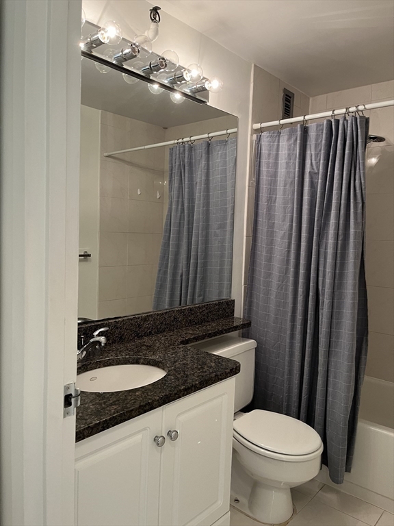 42 8th Street, Unit 5313 Boston, MA 02129 - Photo 14 of 16 a bathroom with a granite countertop sink and a mirror