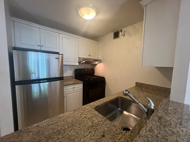 a kitchen with a refrigerator and a sink