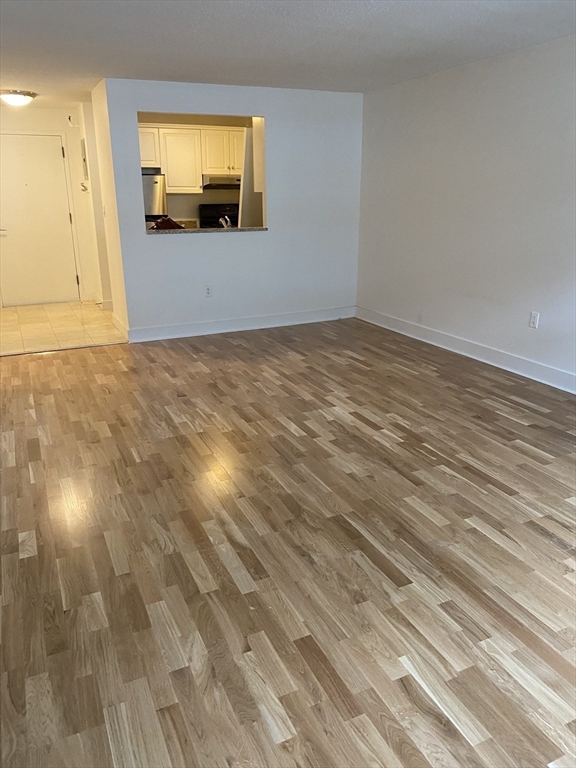 42 8th Street, Unit 5313 Boston, MA 02129 - Photo 8 of 16 a view of empty room with wooden floor