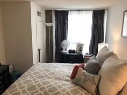 a bedroom with a large bed and a window