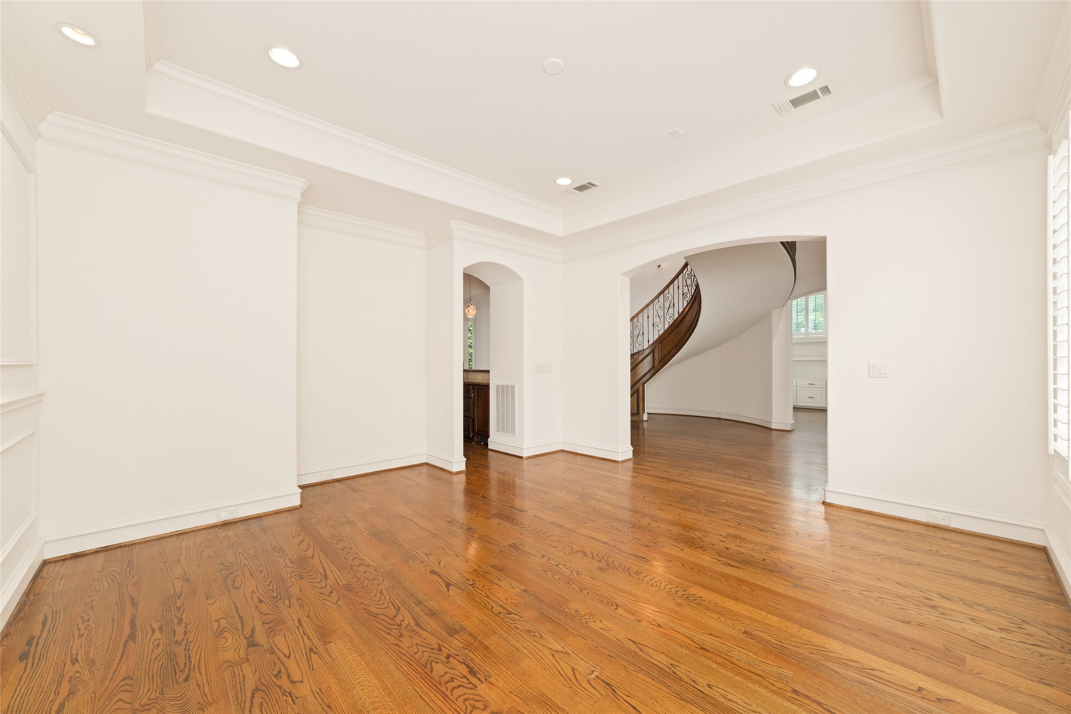 4102 Gramercy Street Houston, TX 77025 - Photo 4 of 35 a view of an empty room with wooden floor and a window