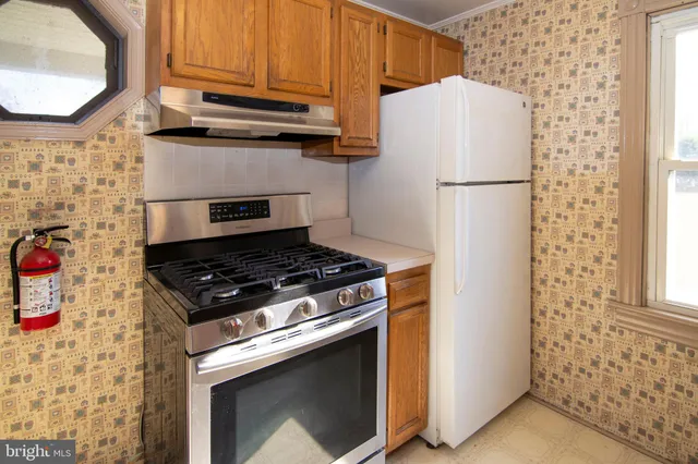 a kitchen with a stove and a refrigerator