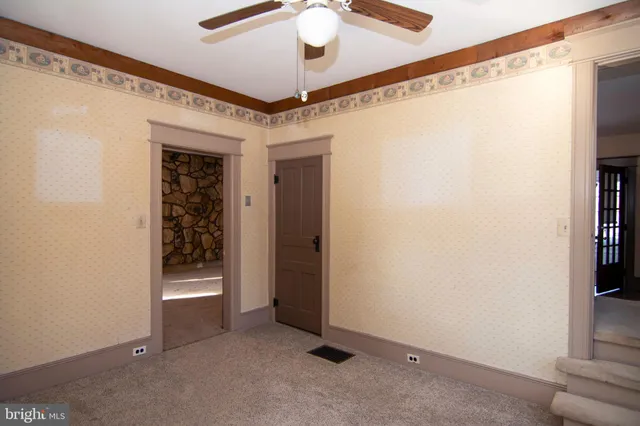 a view of a livingroom with a ceiling fan and window