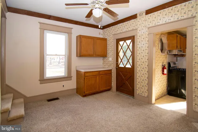 an empty room with windows and closet