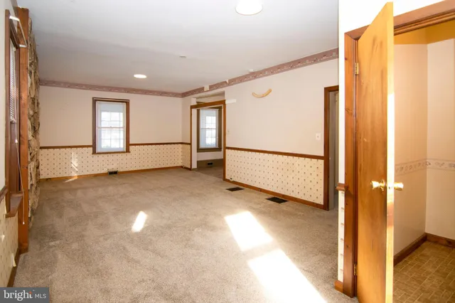 a bathroom with a toilet and a mirror