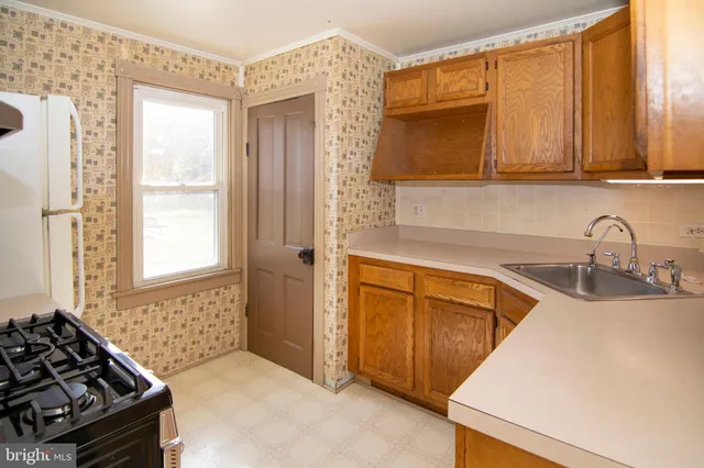 a kitchen with stainless steel appliances granite countertop a sink and a stove
