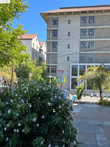 a front view of a building with a garden