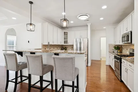 a kitchen with appliances cabinets and a sink