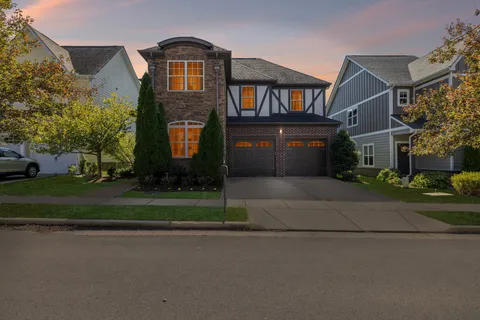 a front view of a house with a yard and a garage