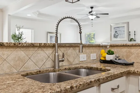 a living room with furniture a fireplace and a large window