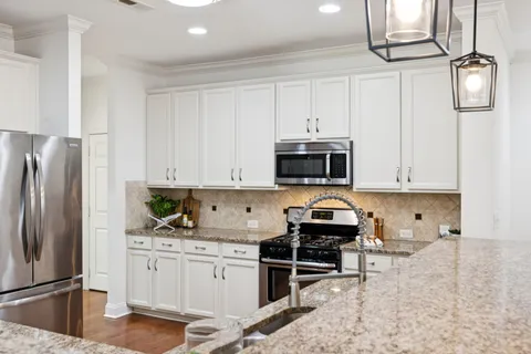 a living room with furniture a clock and a fireplace