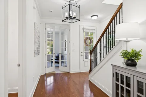 a view of entryway and hall with wooden floor
